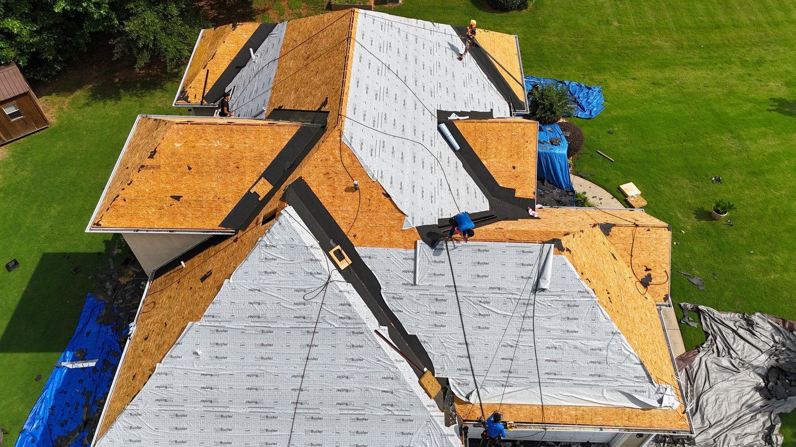 Capstone crew installing architectural shingles, drone view, Middle Georgia