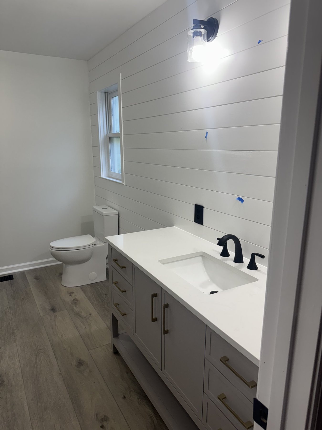 Finished shiplap bathroom remodel with new vanity by Capstone Solutions