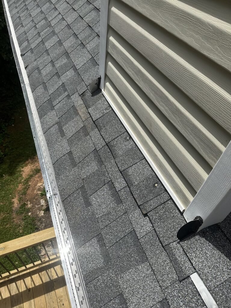 Gutter guards installed on a shingle roof edge