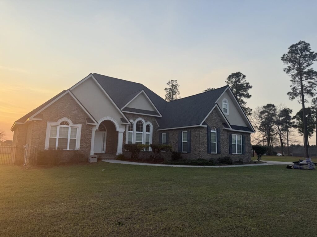 Brick home with a new roof at sunset