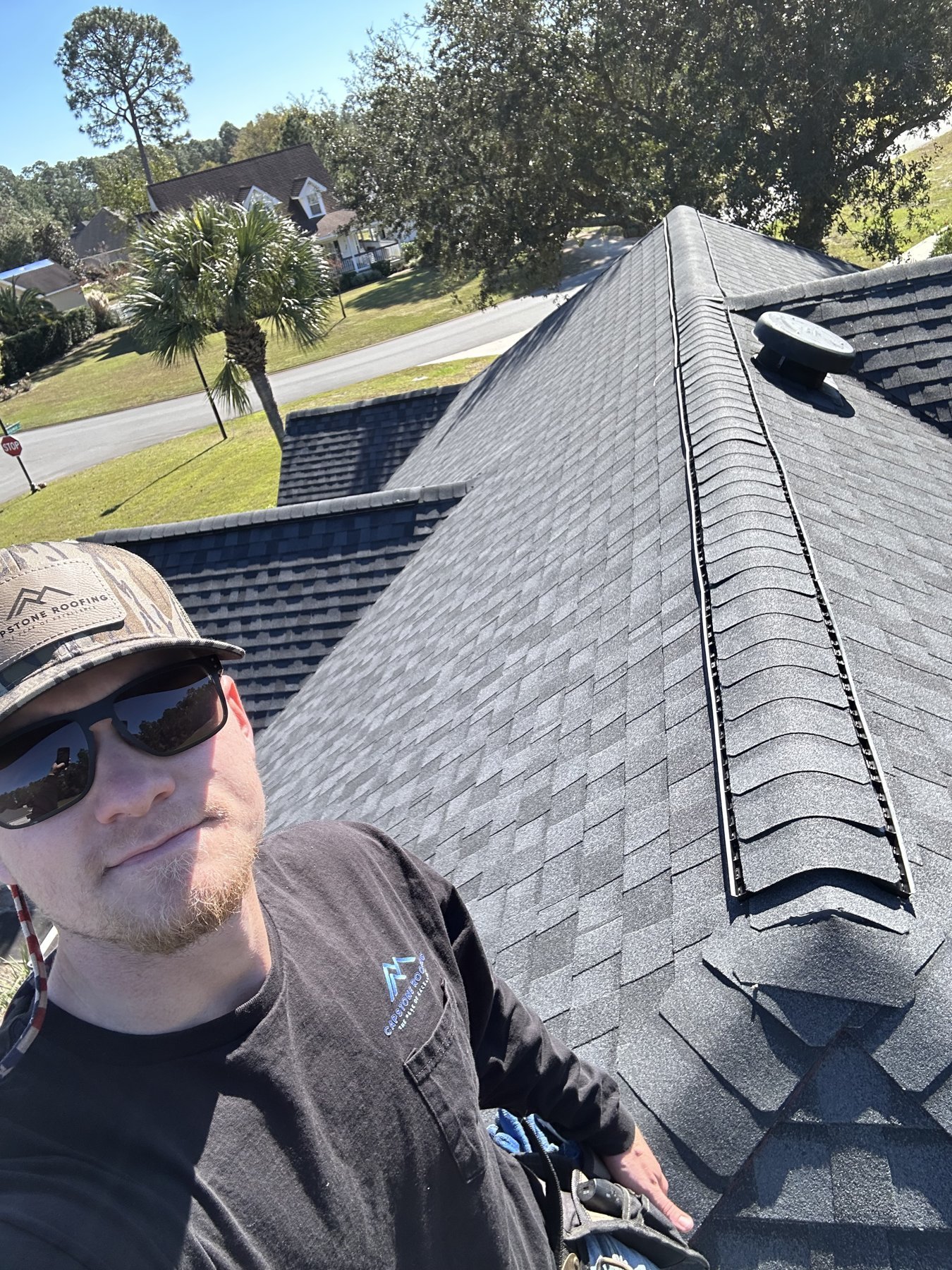 Zach Metzler, owner of Capstone Solutions, on a roof in Middle Georgia