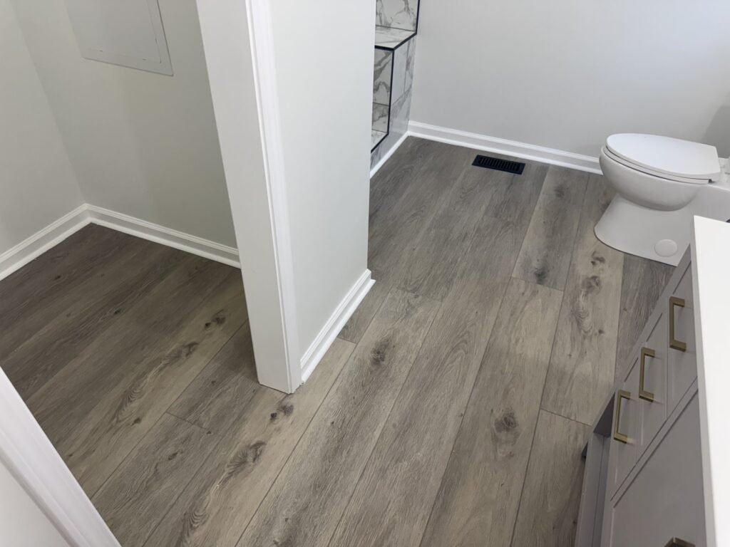 Finished bathroom remodel with new luxury vinyl plank flooring
