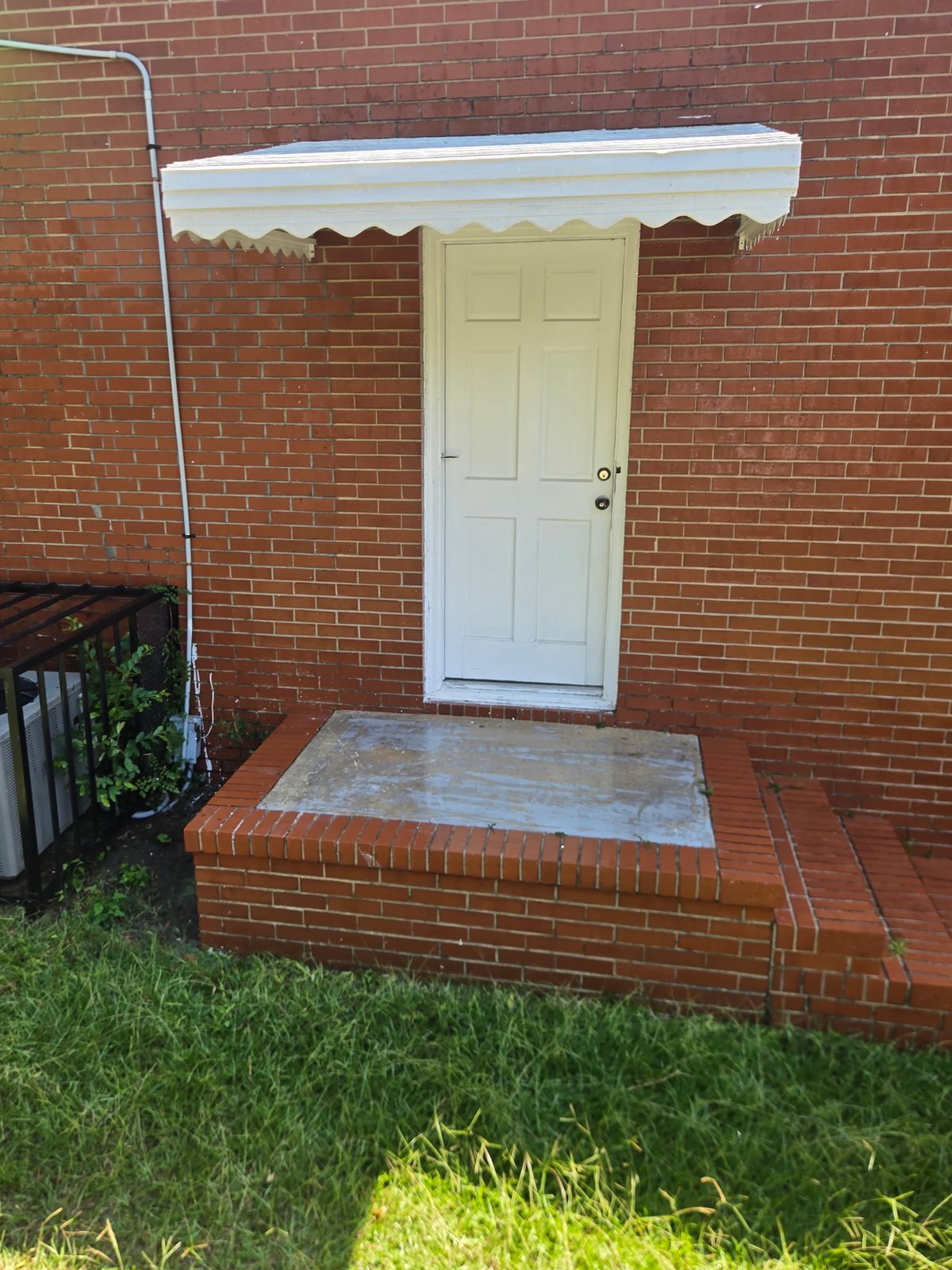 New metal awning over a brick entry stoop