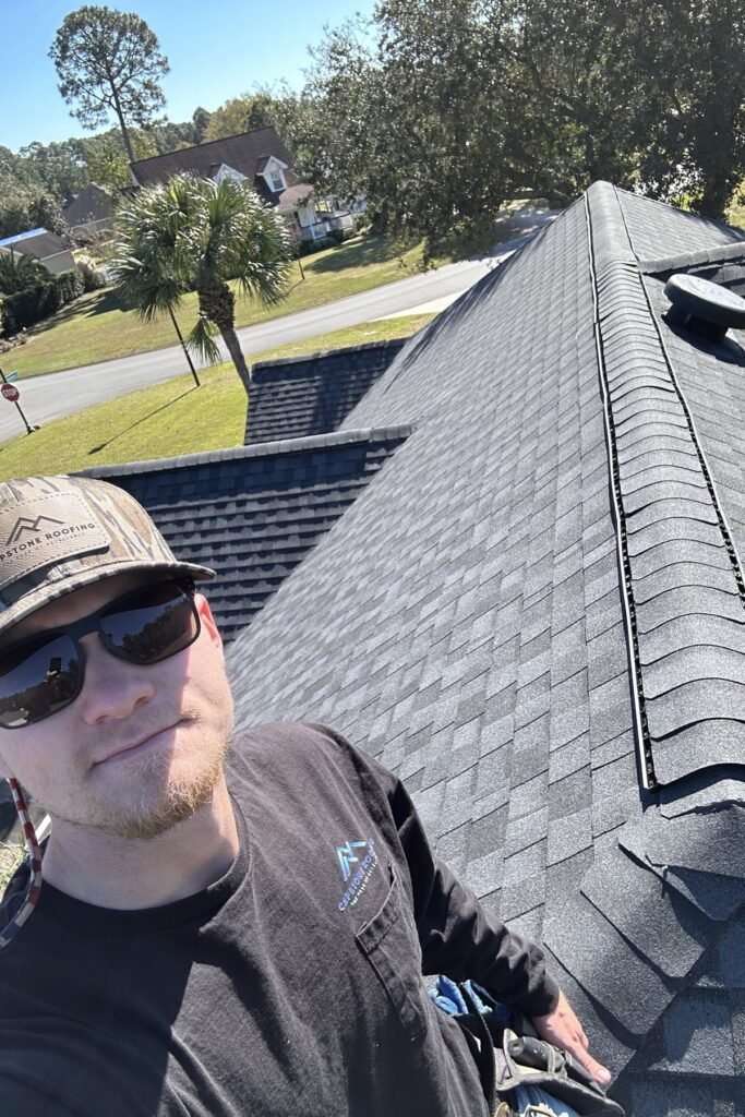 Zach Metzler, owner of Capstone Solutions, on a finished shingle roof in Forsyth, GA
